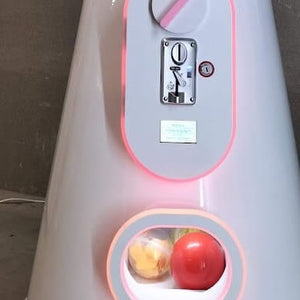 Close-up of the giant gumball machine's coin slot and capsule outlet