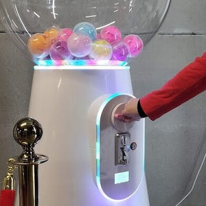 Close-up of the giant white gumball machine's globe filled with colourful capsules