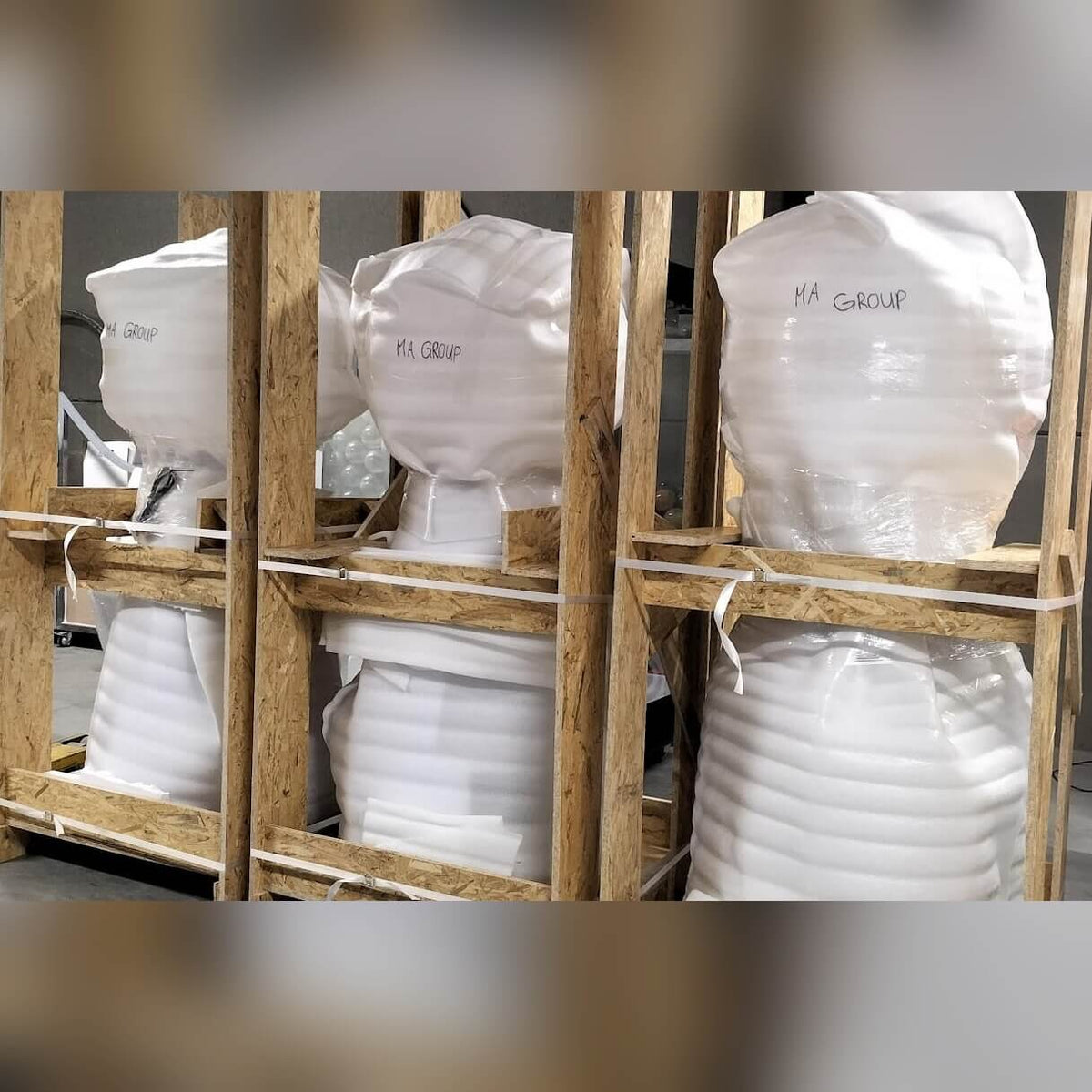Giant gumball machines packed in crates ready for delivery