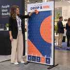 A woman playing the giant Plinko game