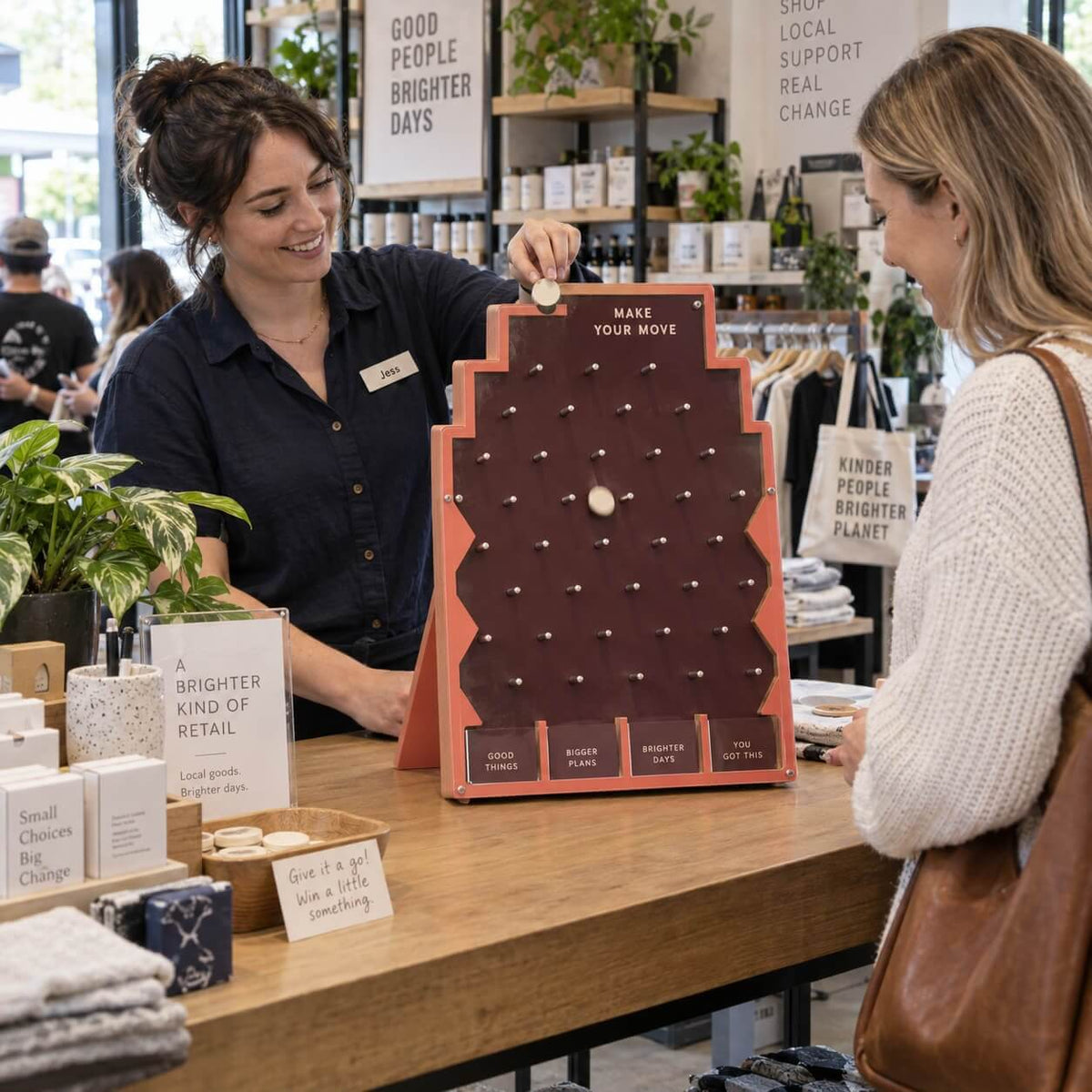 People playing a table-top Plinko game