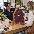 People playing a table-top Plinko game