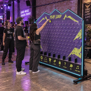 Lit Plinko board at an evening event