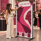 A woman beside a pink branded Plinko board