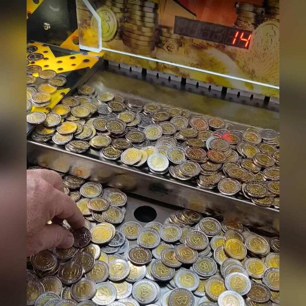 Coins piled on the coin pusher playfield