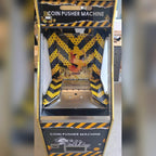 Front of the Gold Digger coin pusher with hazard stripe artwork