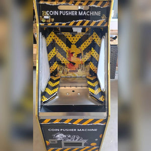 Front of the Gold Digger coin pusher with hazard stripe artwork
