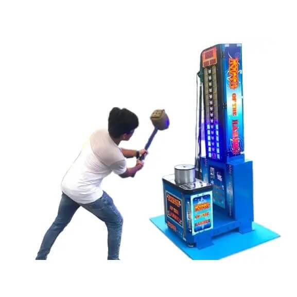 A man swinging the hammer on a high striker