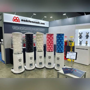 Manual capsule dispenser towers on a trade show stand