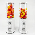 Two manual capsule dispenser towers filled with colourful capsules
