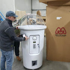 A man collecting a capsule from the milkshake cup machine
