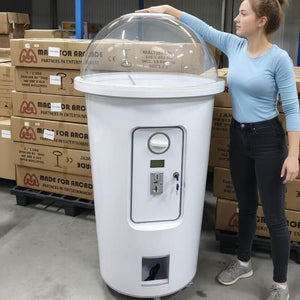 A woman standing next to the 1.7m milkshake cup capsule machine