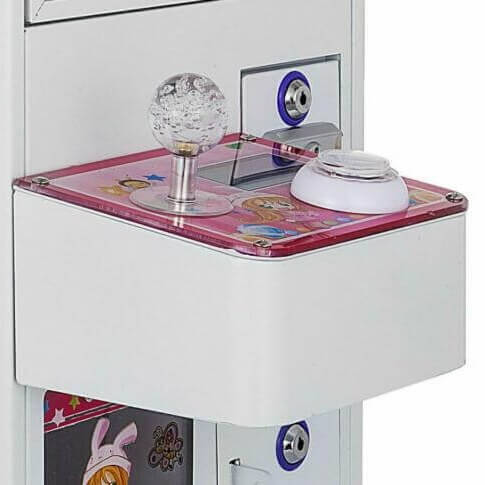 Close-up of a pink mini claw machine