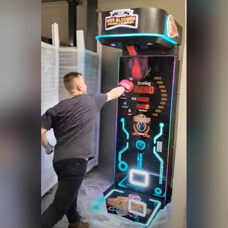 A man punching the Pro Boxing Machine in a showroom