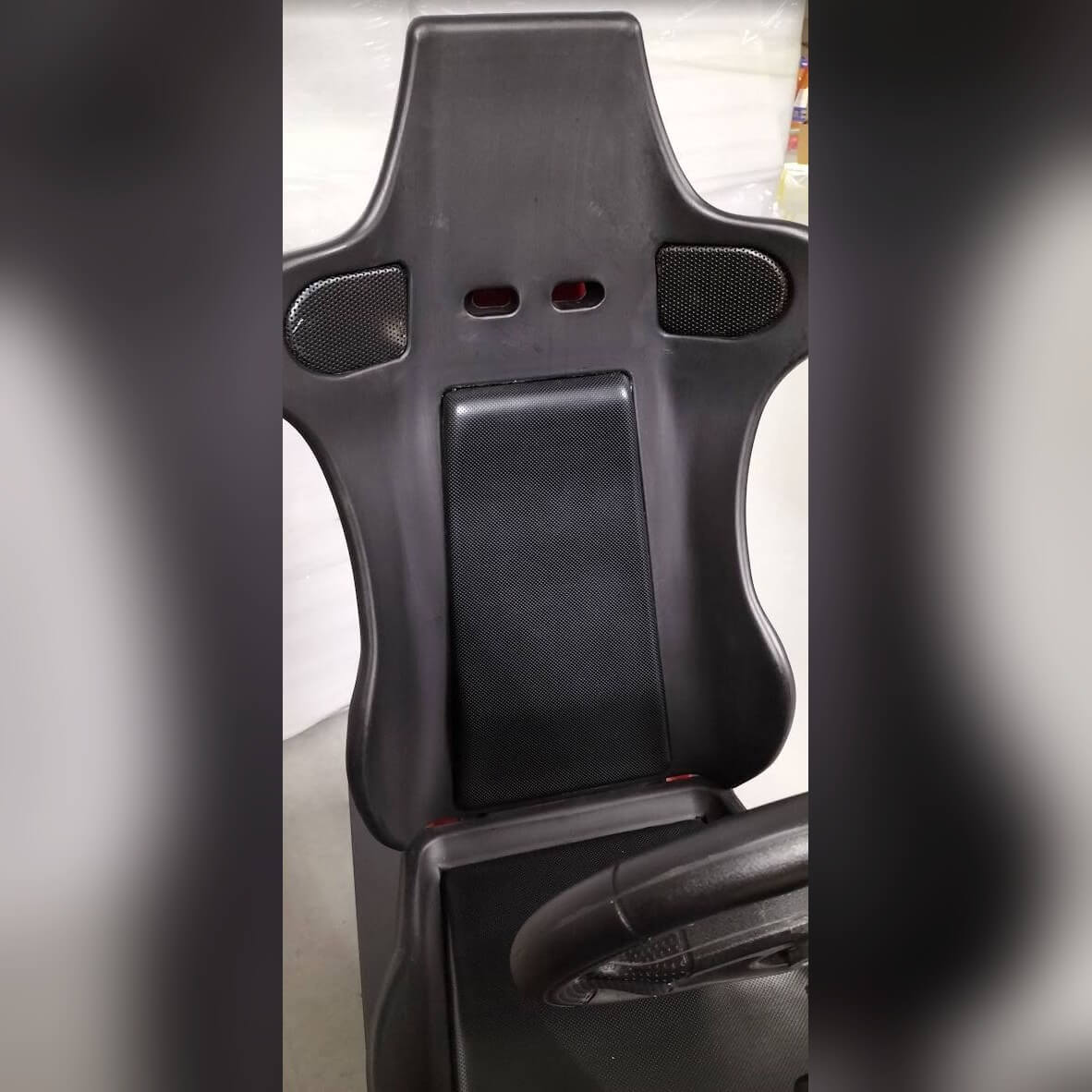 Adjustable racing seat on the arcade simulator