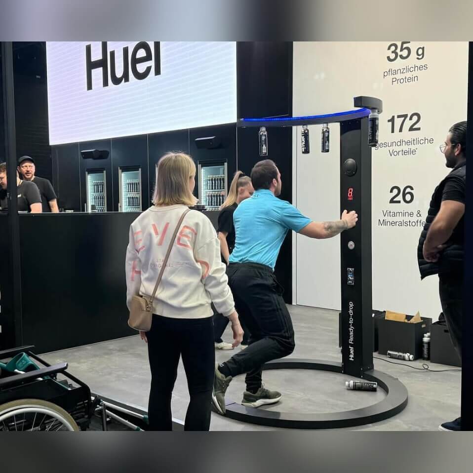 A man catching sticks on a Reaction Ring at a branded exhibition stand