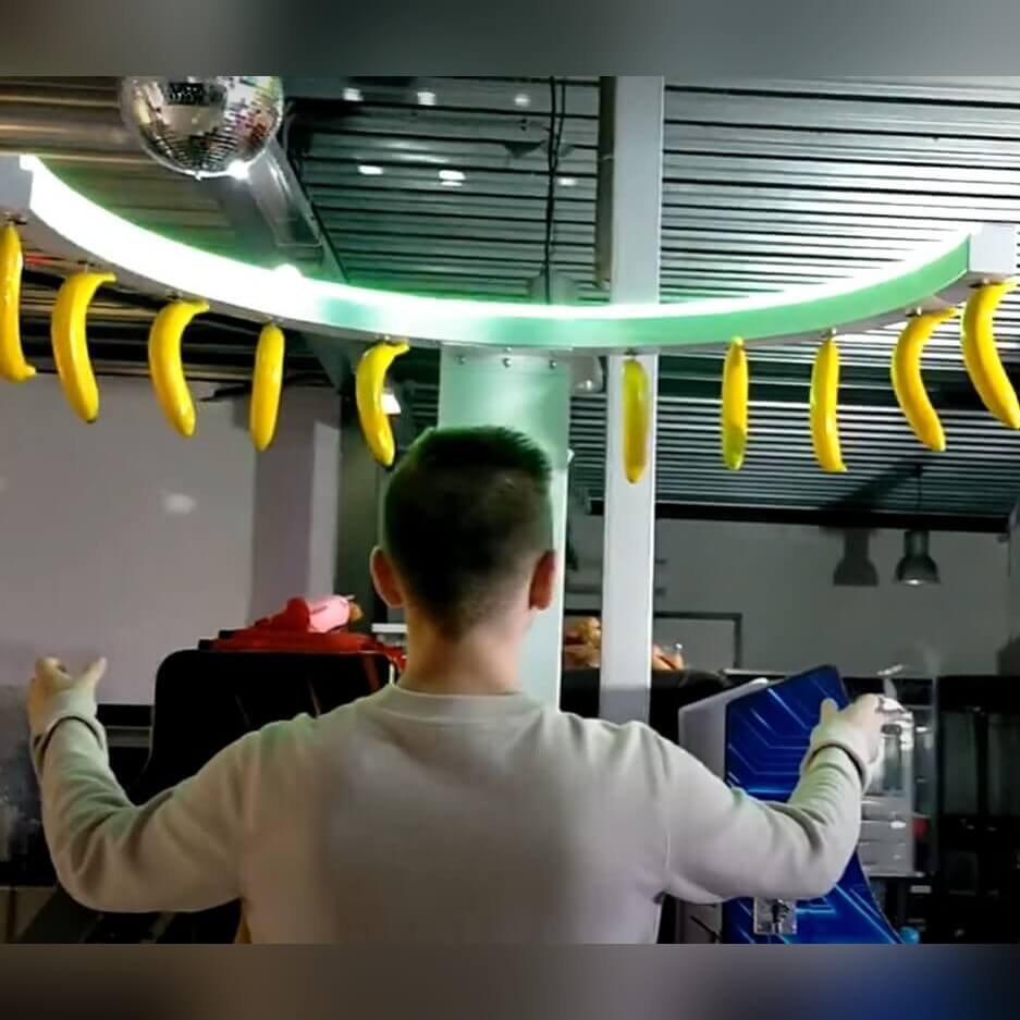 Reaction Ring with coloured prizes hanging from the ring in front of a colourful printed backdrop