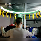 Reaction Ring with coloured prizes hanging from the ring in front of a colourful printed backdrop