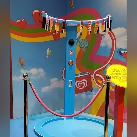 Player reaching for banana-shaped prizes hanging from a lit Reaction Ring