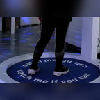 Player's feet on a printed Catch Me If You Can centre carpet inside the Reaction Ring