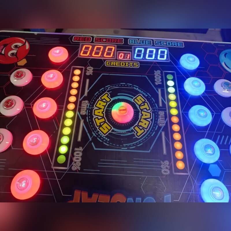 Close-up of the glowing buttons and score displays on the Reflex Rush
