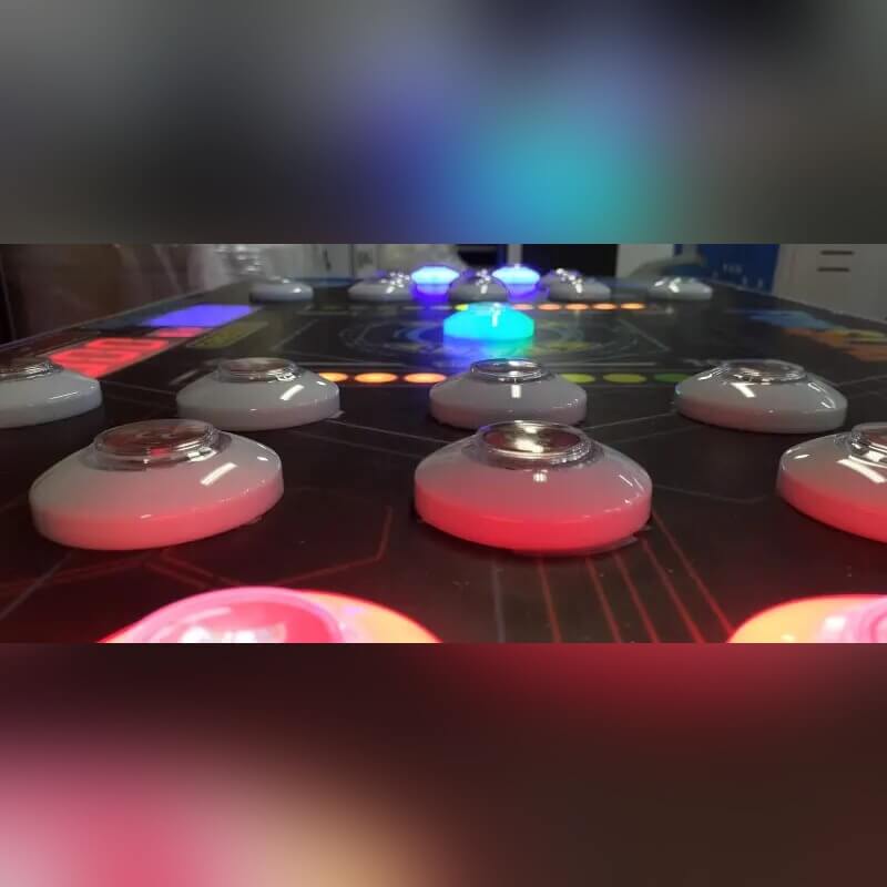 Close-up of glowing buttons on the Reflex Rush table