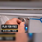 Coin slot on the Reflex Rush, with a sign saying play for free or use coins or tokens