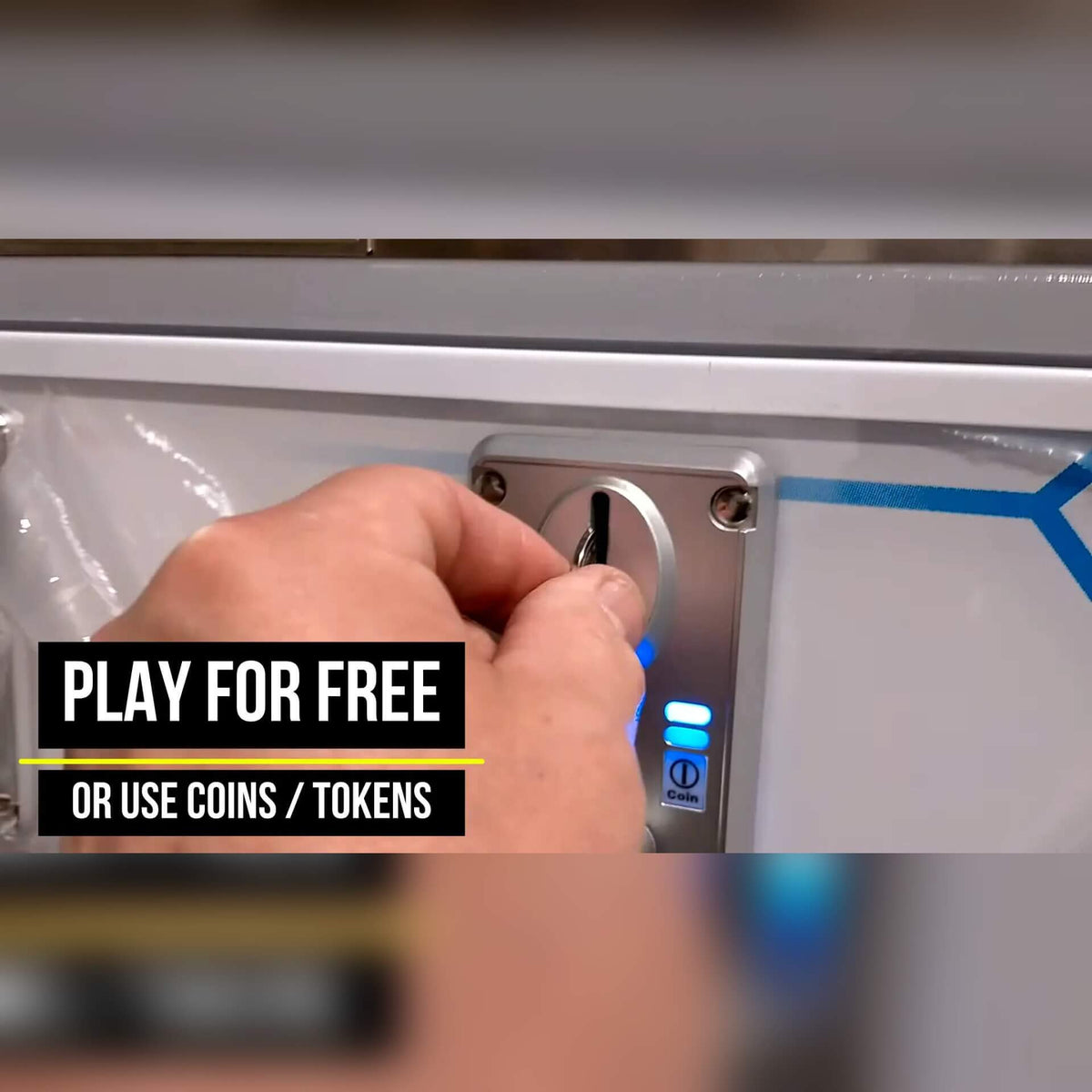Coin slot on the Reflex Rush, with a sign saying play for free or use coins or tokens