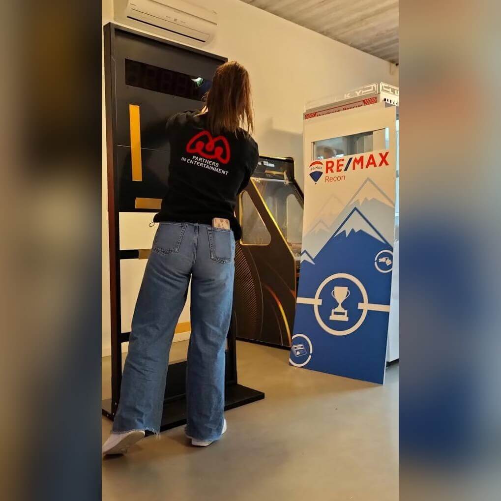 A woman playing a branded Stop the Clock totem at an event