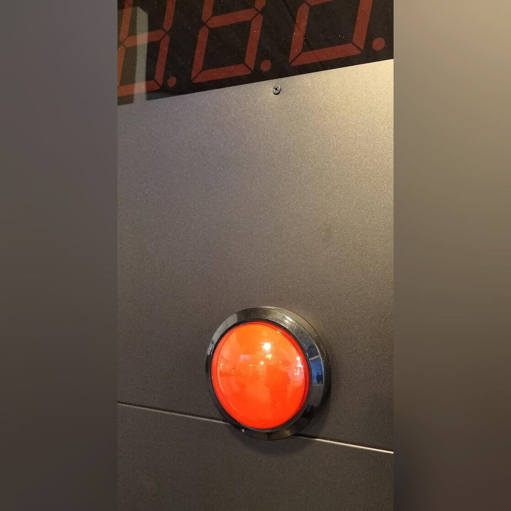 Close-up of the red button on the Stop the Clock totem