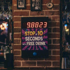Wall-mounted Stop the Clock game in a bar offering a free drink for stopping at 10 seconds