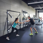Two people racing to hit the lit targets on a MadeForArcade Strike-a-Light batak machine in a gym