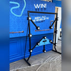 Strike-a-Light batak machine in front of a blue branded event wall