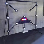 Black Strike-a-Light batak machine with lit targets against a grey wall