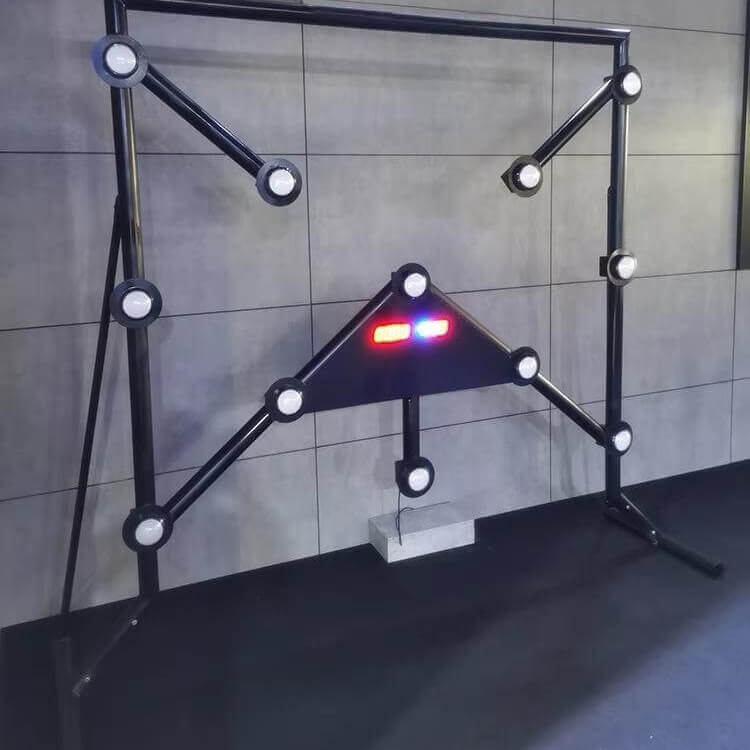Black Strike-a-Light batak machine with lit targets against a grey wall