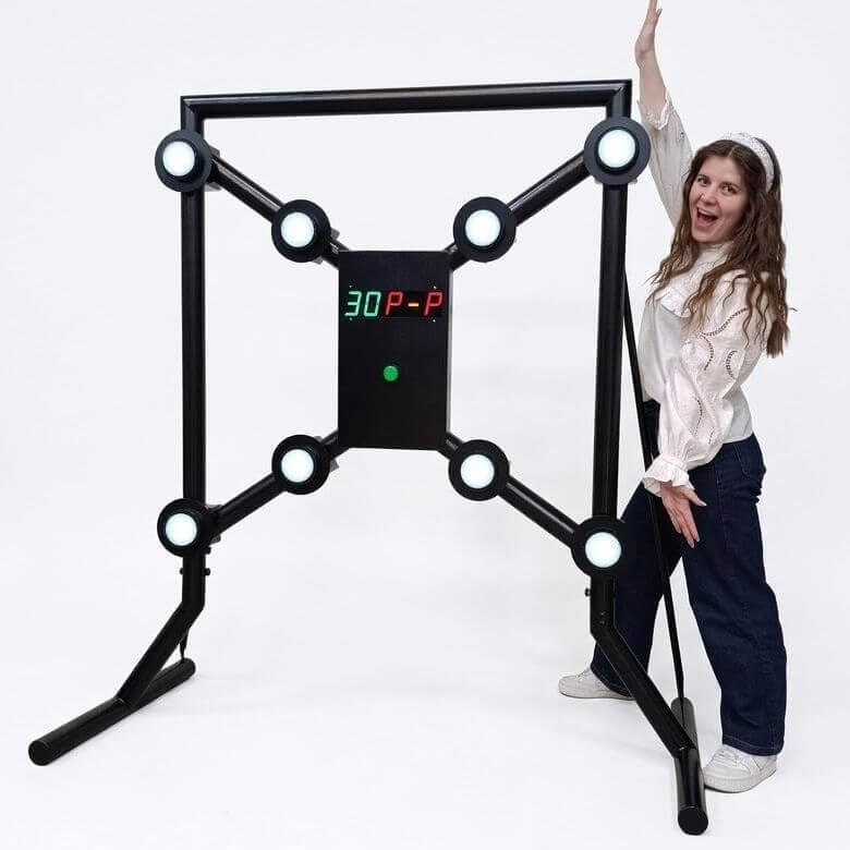 A woman standing beside a MIDI Strike-a-Light batak machine to show its size