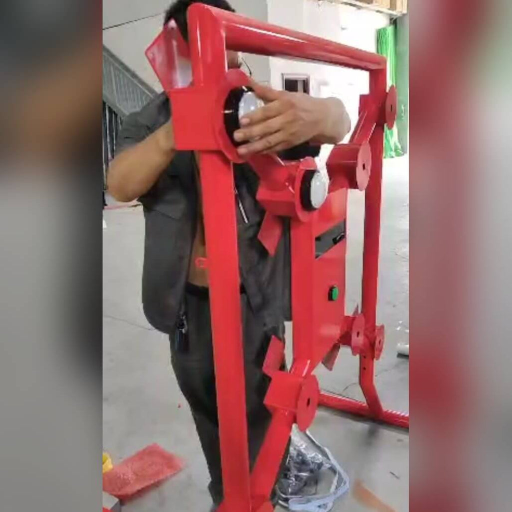 Close-up of hands fitting a target on a red Strike-a-Light batak machine
