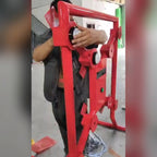 Close-up of hands fitting a target on a red Strike-a-Light batak machine