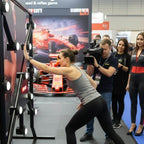 A woman playing Strike-a-Light at a motorsport event as photographers watch