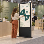 A woman spinning the wheel on the touchscreen kiosk