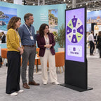 A couple trying the prize wheel kiosk