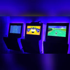 Wall-mounted arcade machines glowing blue