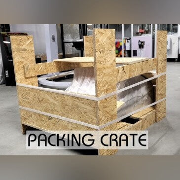 Wall-mounted arcade machine in its wooden packing crate