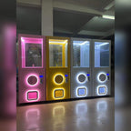 Four MadeForArcade XXL capsule vending towers with colourful neon lighting