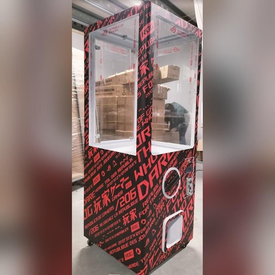 Red XXL capsule vending tower with a full-colour wrap
