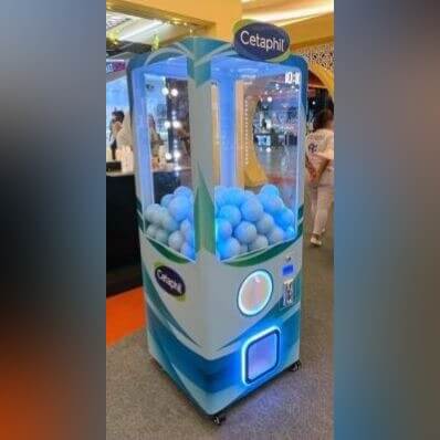 Blue XXL capsule vending tower at an event
