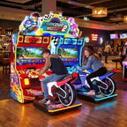 Two teenagers racing on Parkour Motor II DX at a bowling alley in the evening