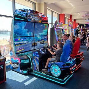 Racing XTreme DX motion racing arcade machine in a UK seaside arcade with a child racing