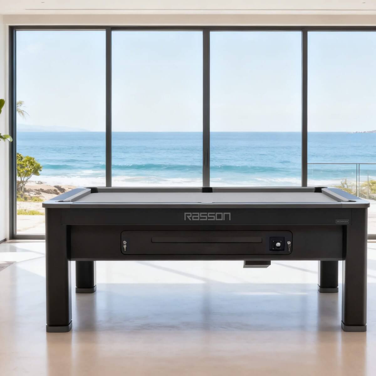 Rasson Ironman pool table in a bright living room with sea views