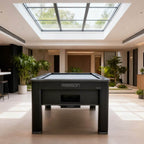 Black Rasson Ironman pool table under a skylight in a modern home